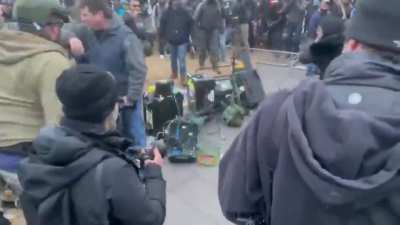 A mob of fascists assault a group of news reporters and proceeds to destroy their equipment