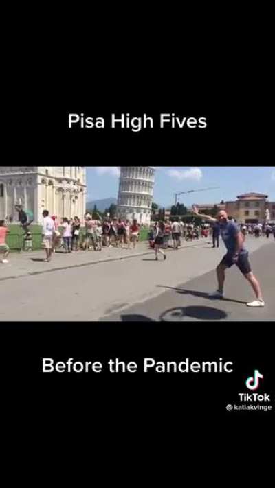 High fiving tourists at Pisa