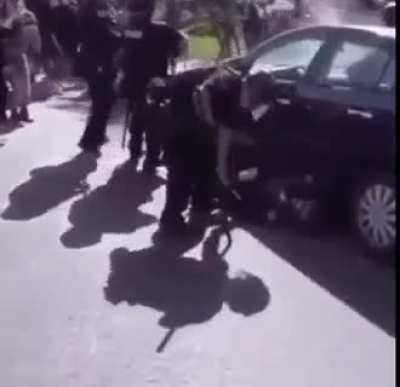 Protester helps drag police officer to ambulance after violent protester knocks him out.