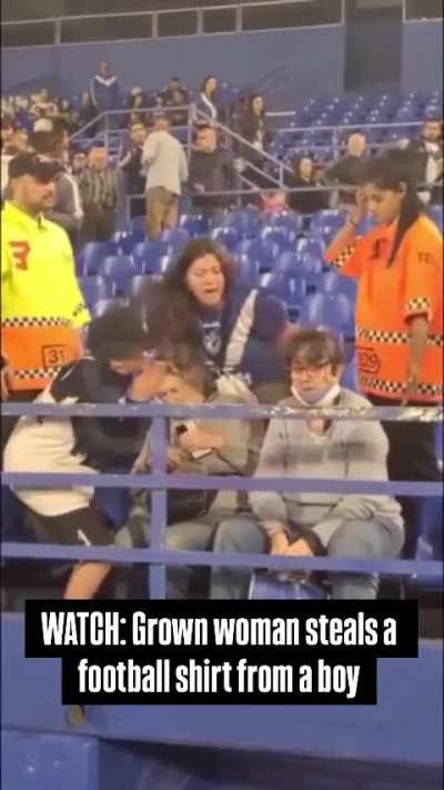 Grown women steals a football shirt from a boy 