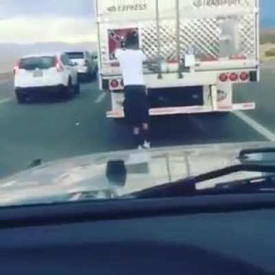 Tearing a confederate flag bumper sticker off an 18 wheeler in traffic