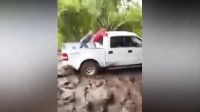 These guys think they can push their truck out while standing on the flatbed...