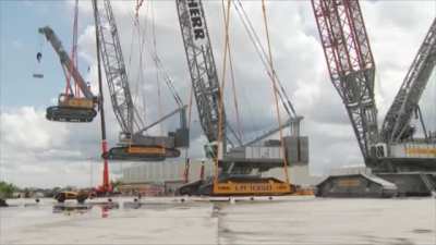 Gigantic crane lifting a big crane lifting a medium crane lifting a small crane lifting a tiny crane