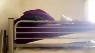 Girl tries to do yoga with a bed