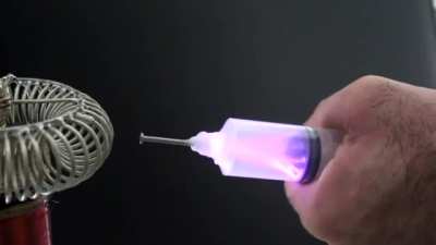 Extracting electricity from a tesla coil using a syringe