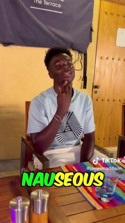 Saka taking time to show his students how to spell