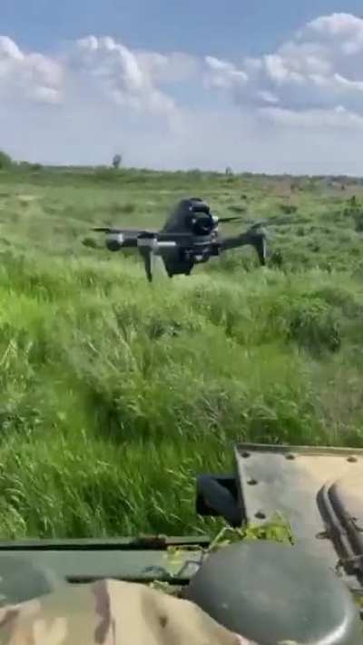 Warfare 2022 - Ukrainian troops launch a drone from a moving vehicle, pilot wearing VR goggles
