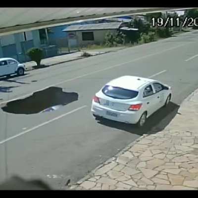 Car drives into sinkhole