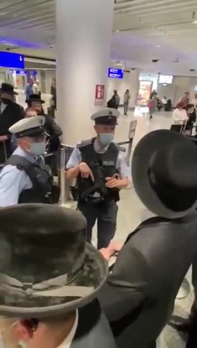 German Policeman reacts to being called a Nazi at the gate of Lufthansa 1334.