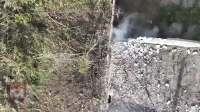 A Ukrainian drone drops grenades into a small opening on a building some Russians were hiding in.