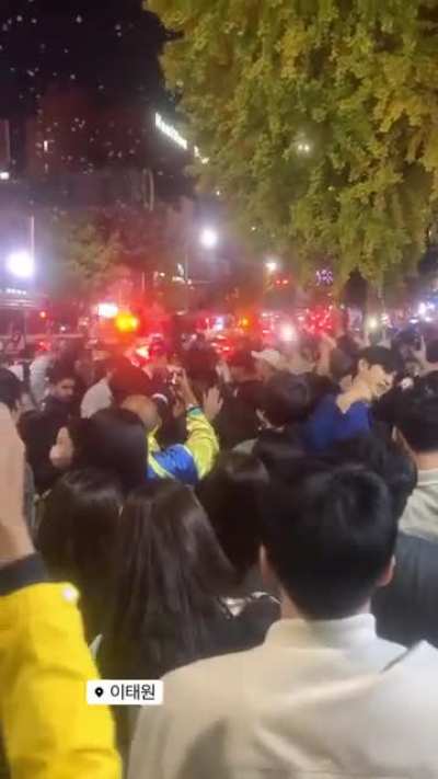 Itaewon, Seoul, S.Korea, while people get squashed and stomped, many critical in need of CPR, rowdy crowd dancing &amp;amp; singing Sex on the Beach, blocking ambulances and the staff.