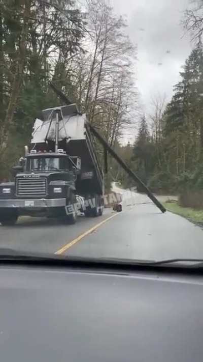 Girl uses the force when dump truck driver drags utility pole down the road toward her