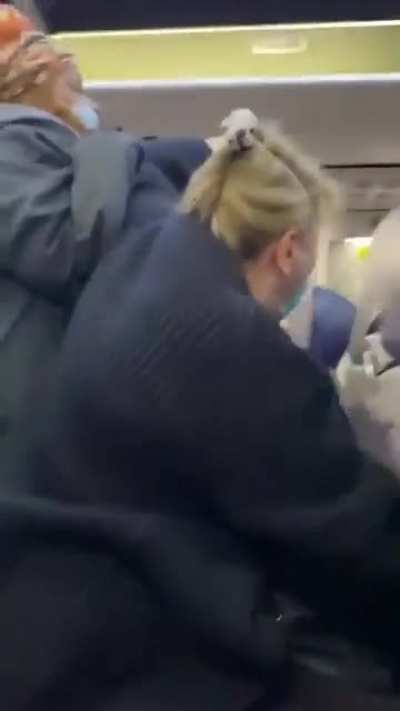 Woman on airplane blocks the way for people and pretends she&rsquo;s getting attacked