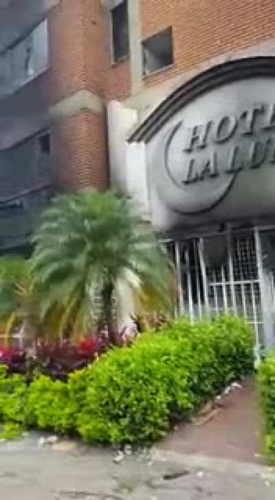 Man crying in front of his hotel after it being burnt yesterday in Colombia's protests