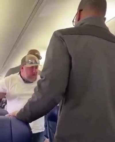 Fake Larry the cable guy loses it on plane.