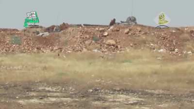 Opposition BGM-71 TOW team engages an SAA T-55 peeking over a berm - Handarat Camp, Aleppo - 7/22/2015