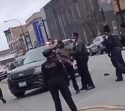 An officer hits handcuffed man and then