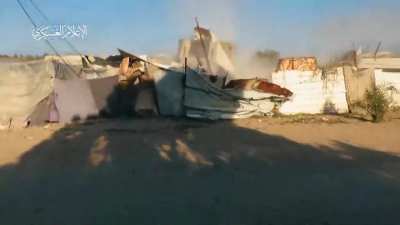 Palestinian shoots RPG directly at the cab of an Israeli bulldozer demolishing buildings