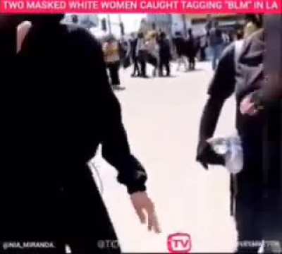 BLM protestor confronts white provocateurs tagging buildings.