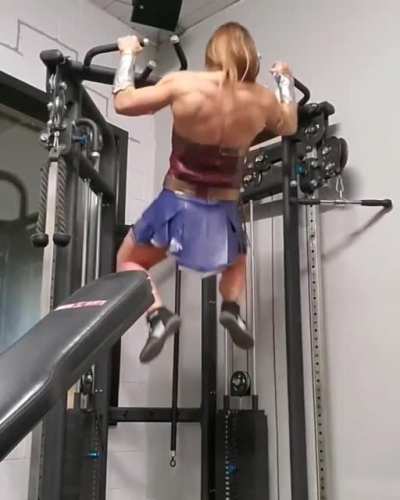 Wonder Woman doing some pull-ups.