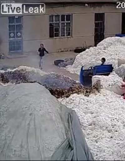 Using a lighter to open a bag at a cotton warehouse