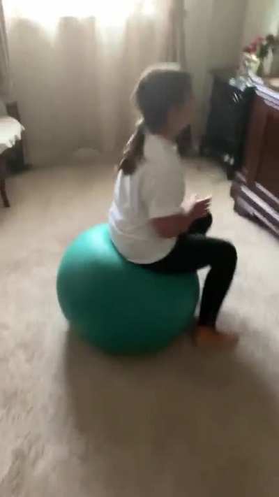 A little falls off a yoga ball