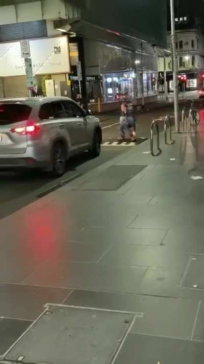 Man walks in the middle of the road