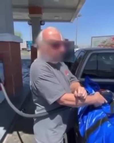 Couple confronting a guy filling the back of his pickup truck with gasoline