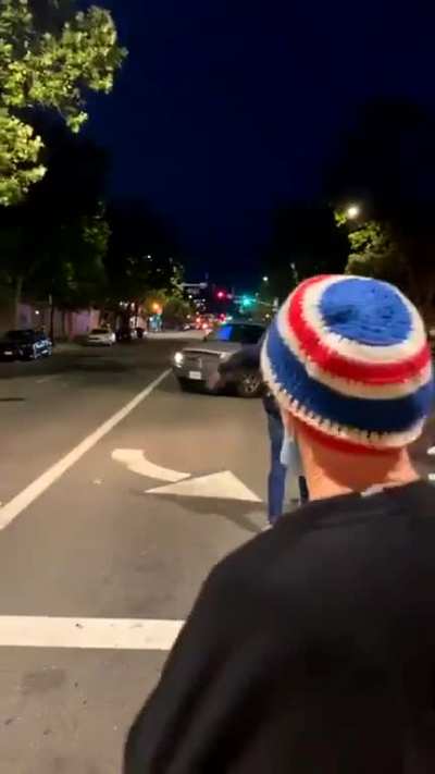 Car runs over rioter