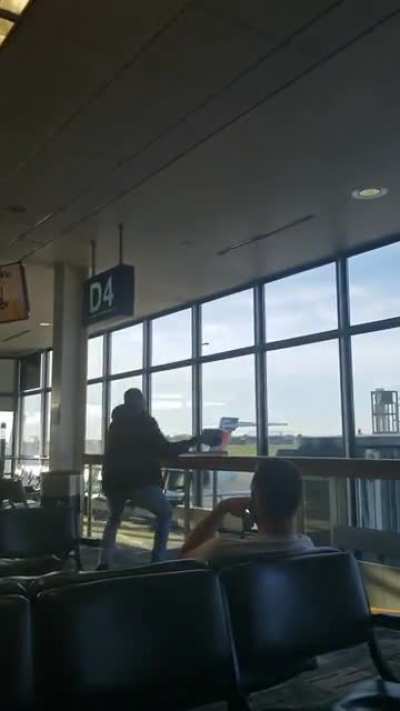 And the crowd goes wild! Guy tries catching a bat in Minneapolis airport