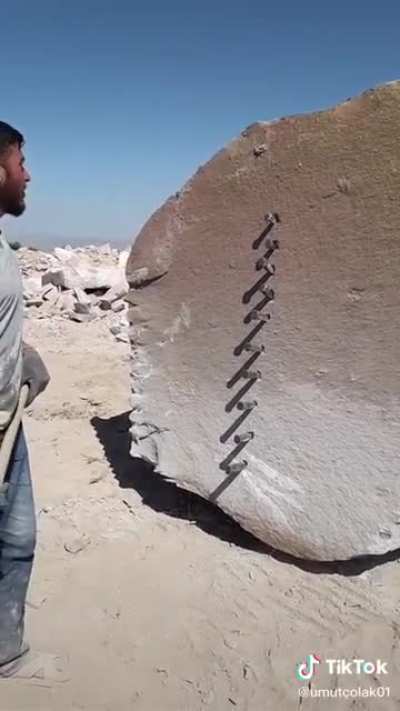 This guy splitting a giant rock very neatly
