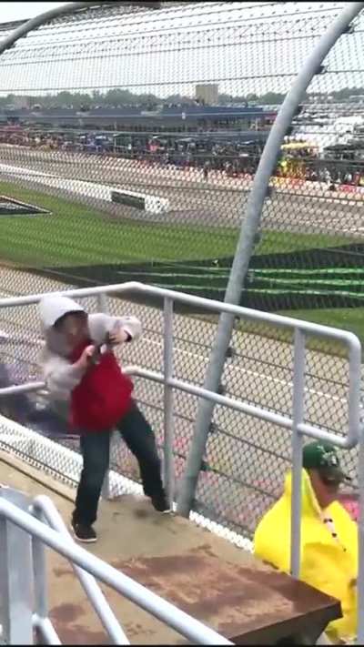 Kid experiencing strong crosswinds at a Nascar race