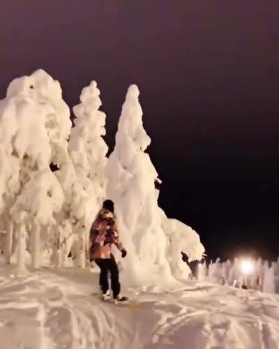 Snowboarding at night time.