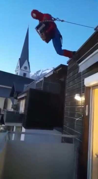 trying to play accordion hanging from a roof dressed as spiderman?