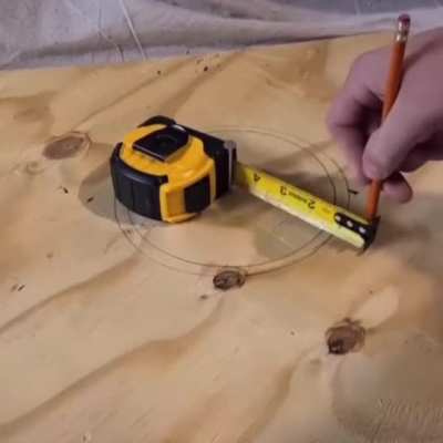 Drawing a circle with a tape measure and a nail