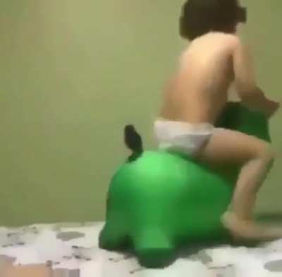 Kid on green thing.