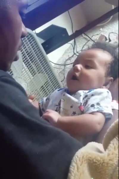 Baby boy says "I love you" to Dad copying his lip movements.