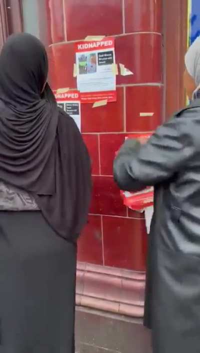Women in London tear down posters for missing British citizens in Gaza