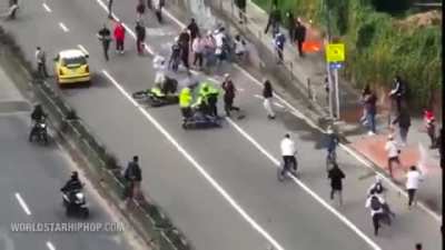 Cops on bikes hitting skateboarders during a Skateboard day