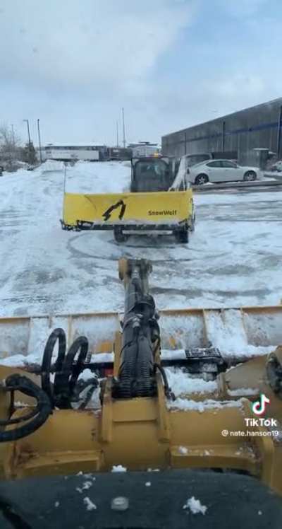 Dudes plowing the parking lot