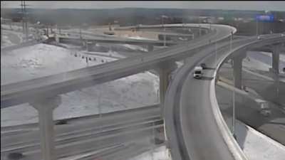 Truck misses exit ramp on bridge.