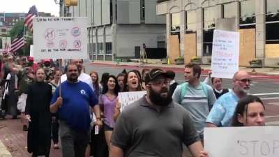 Anti-mask protesters march around the Indiana State House chanting “USA” & “We Will Not Comply.”