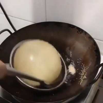 Making Bhatoora (deep-fried leavened bread)