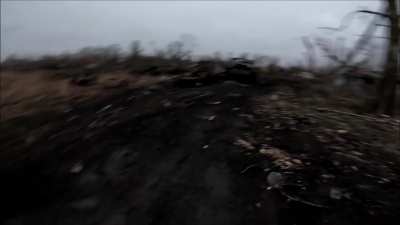 Russian soldiers moving by destroyed Russian vehicles and an Ukrainian kamikaze drone in the village of Zelenyi Shylakh, Kursk Oblast. December 2024