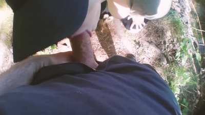 Gagging on his dick outdoors next to a walking trail