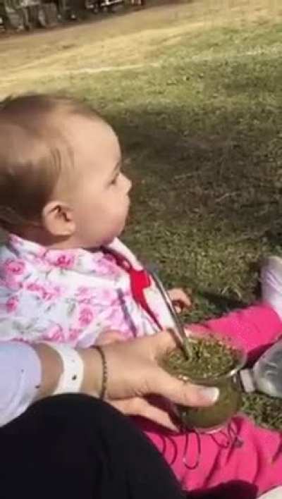 Infant drinking tea for the first time