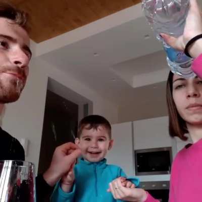This sweet boy in Italy believes by holding his parents&rsquo; hands he can make the water travel from one person to the other