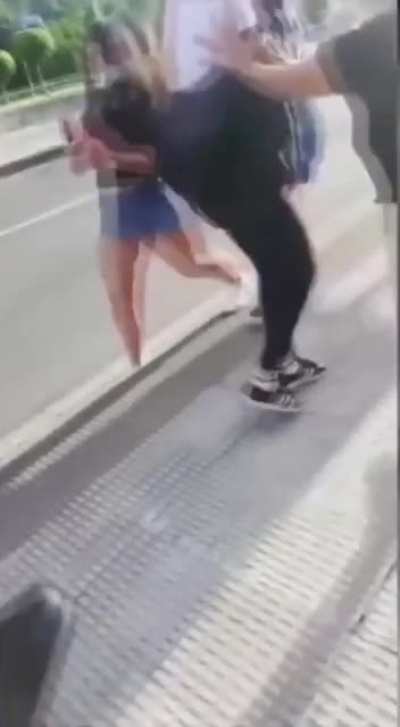 Girl tries to shove her friend into someone else. Doesn't go as planned.