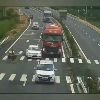 Car in China tries to pull in front of truck