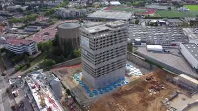 Using vertical water cannons to reduce dust and debris from building demolition